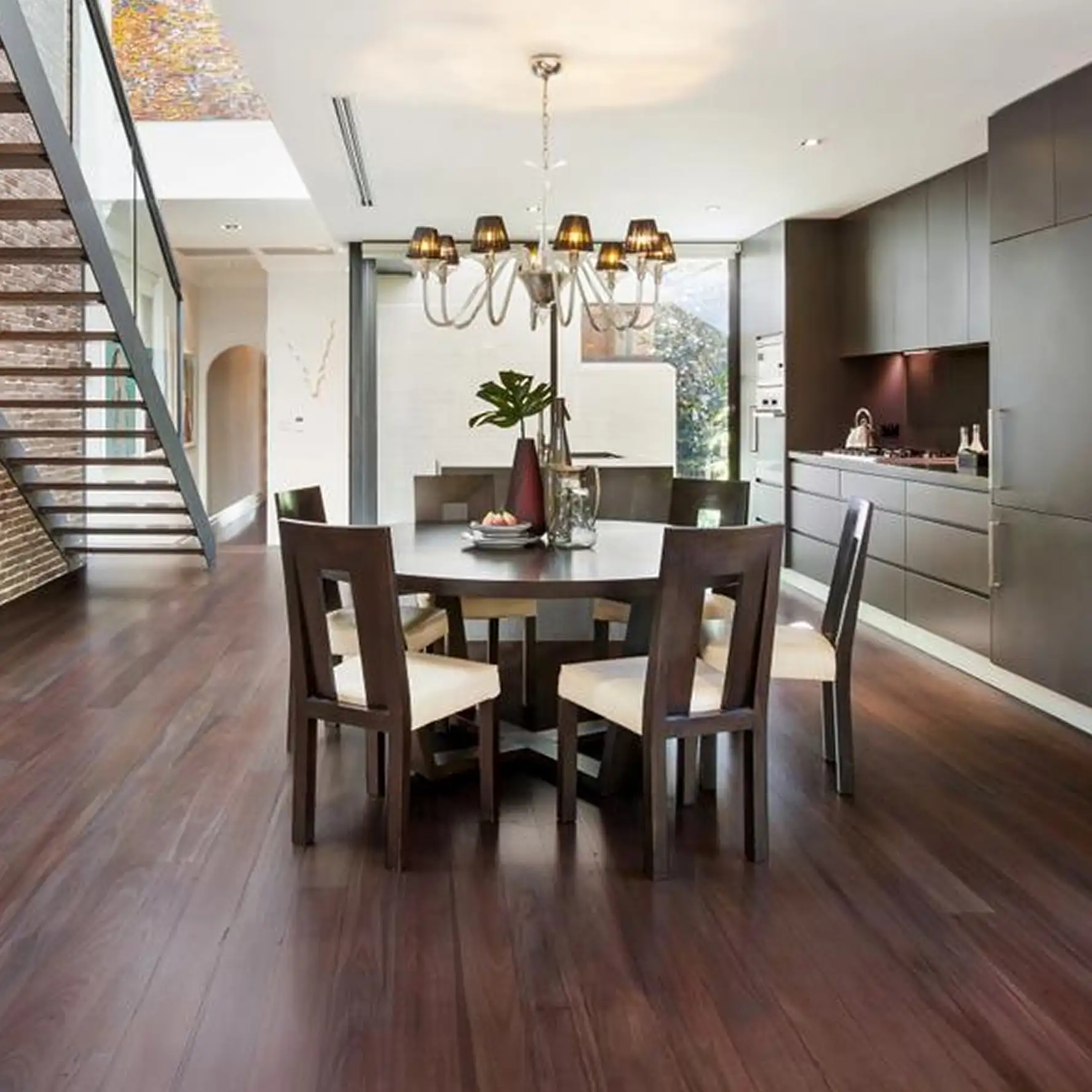 Deep reddish-brown Merbau floor in an open-plan Sydney dining and kitchen space
