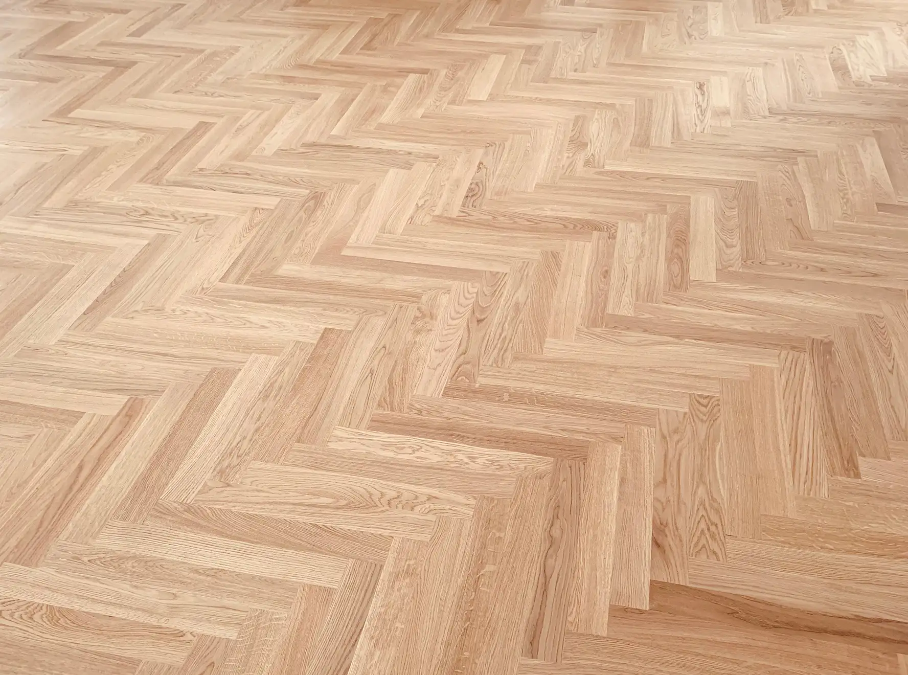 Geometric parquetry timber pattern after professional refinishing