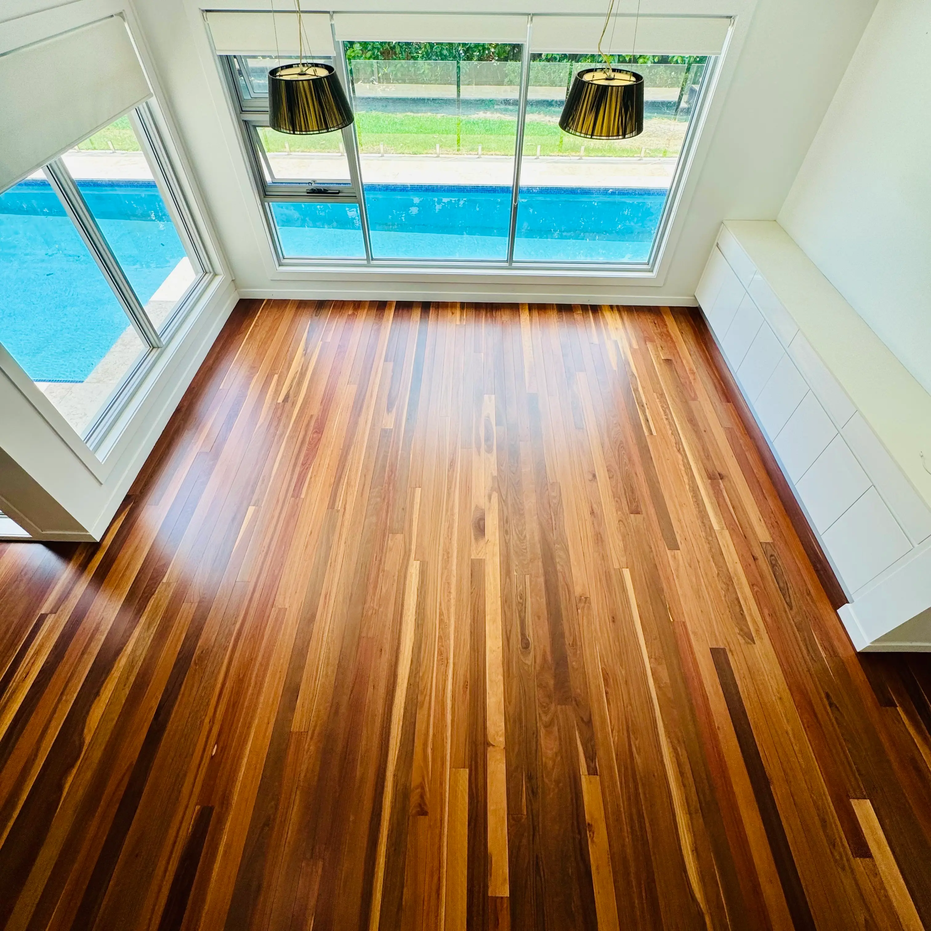 Gloss-finished reddish-brown Merbau floor in a Bella Vista Sydney home