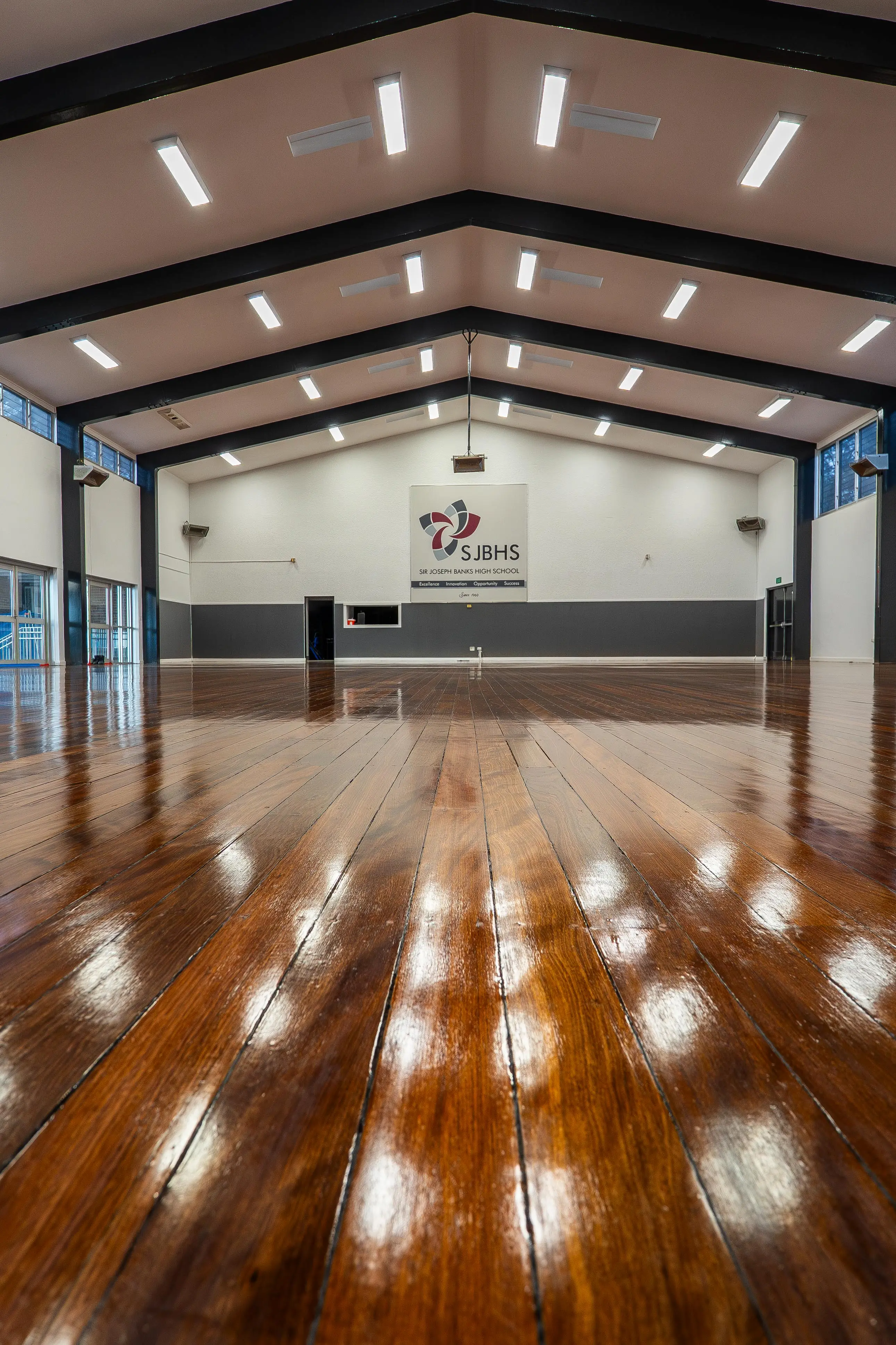 High-gloss deep reddish timber hall floor after professional finishing, Revesby NSW